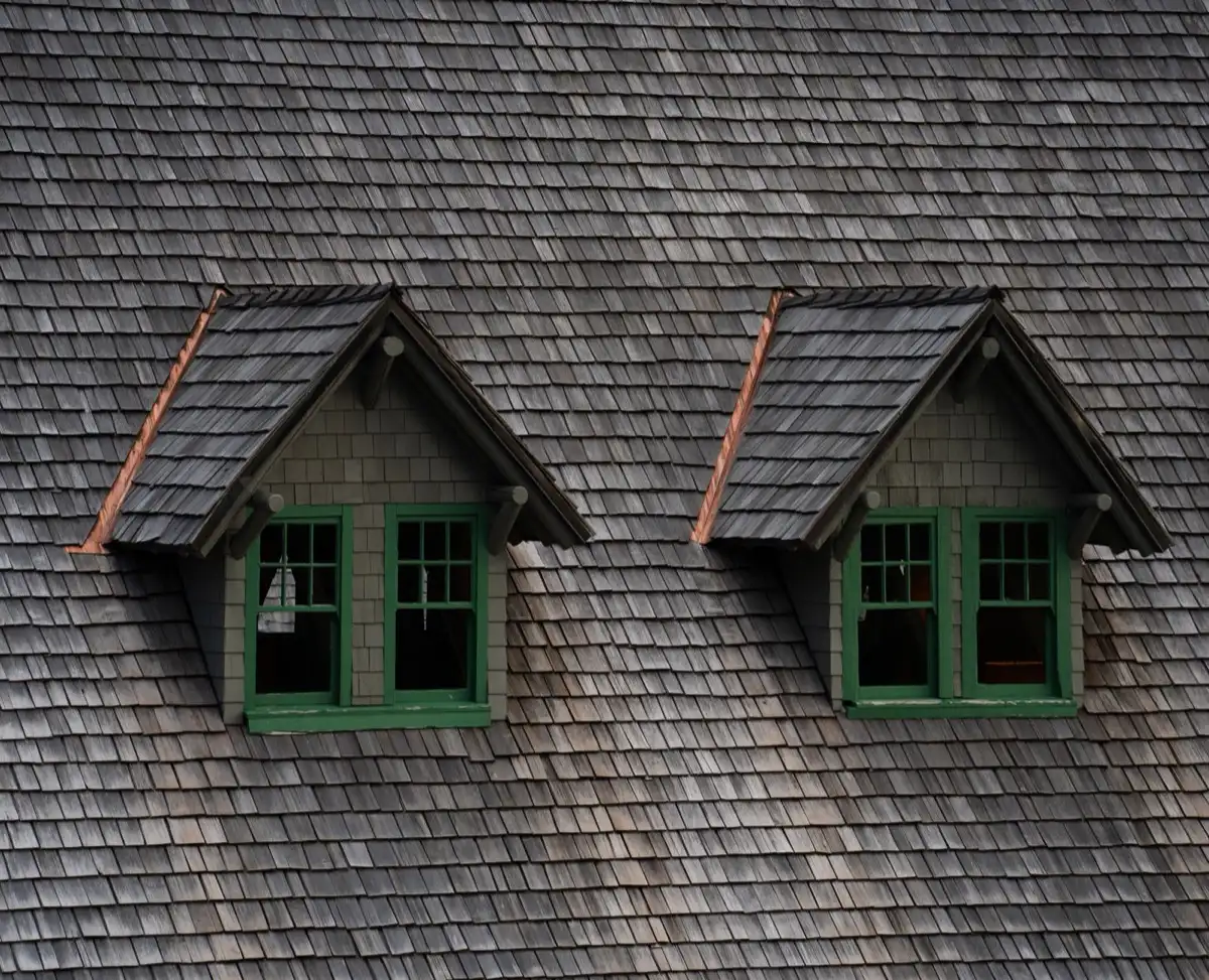 Dormers on a shingle roof in Garland, TX, where step flashing and kickout flashing carry water past the walls
