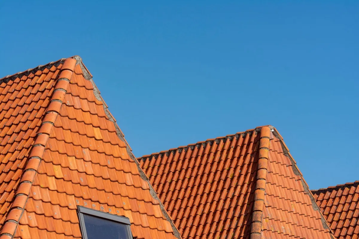 Clay barrel tile rooflines on homes in Garland, TX