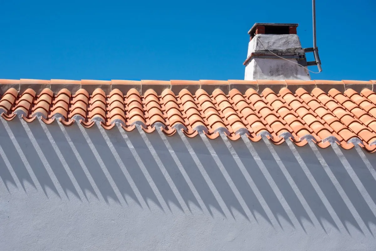 Roof ridge line and chimney on a home in Garland, TX